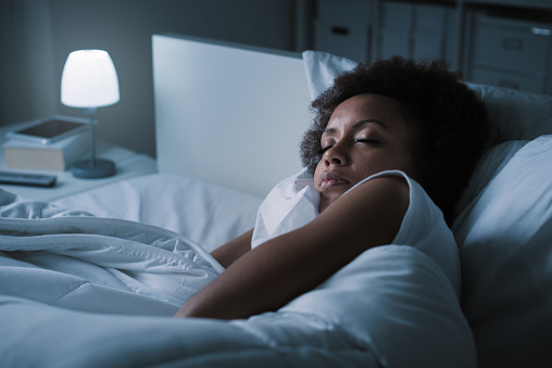 Young black woman peacefully sleeping after receiving sleep apnea treatment